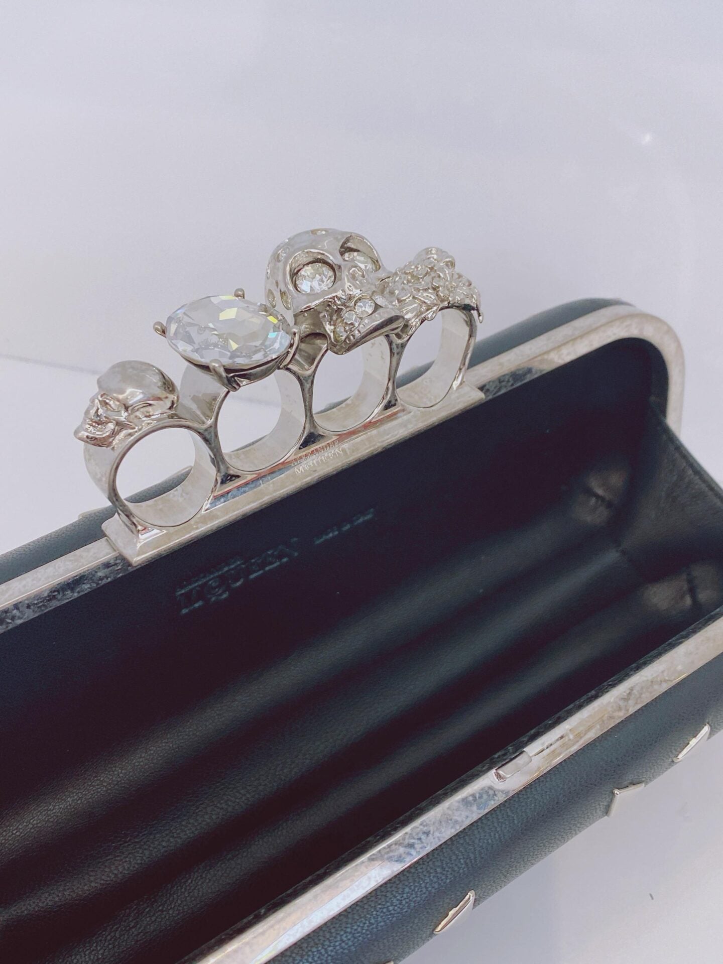 BLACK NAPPA TRIANGLE STUDDED KNUCKLE CLUTCH