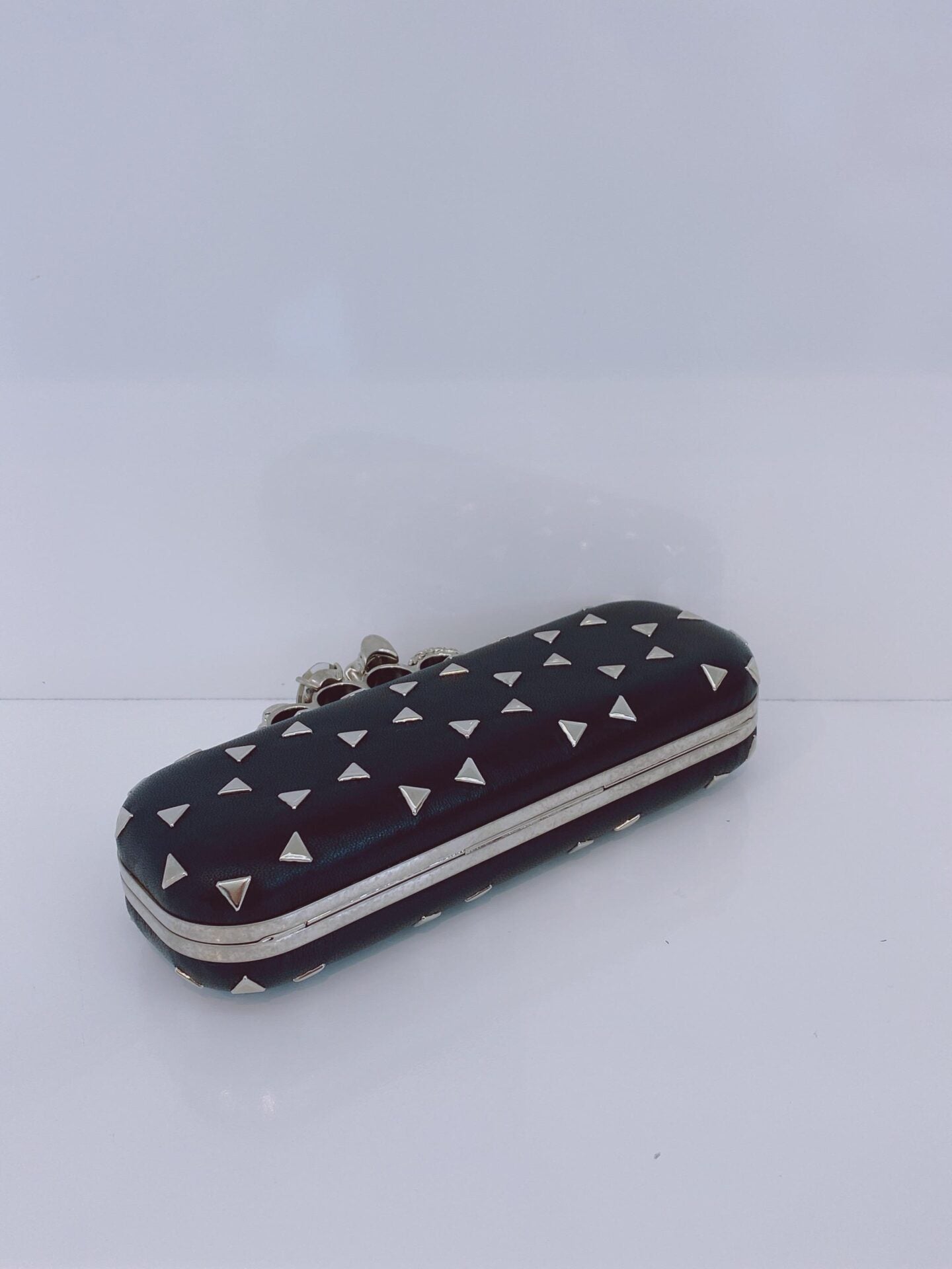 BLACK NAPPA TRIANGLE STUDDED KNUCKLE CLUTCH