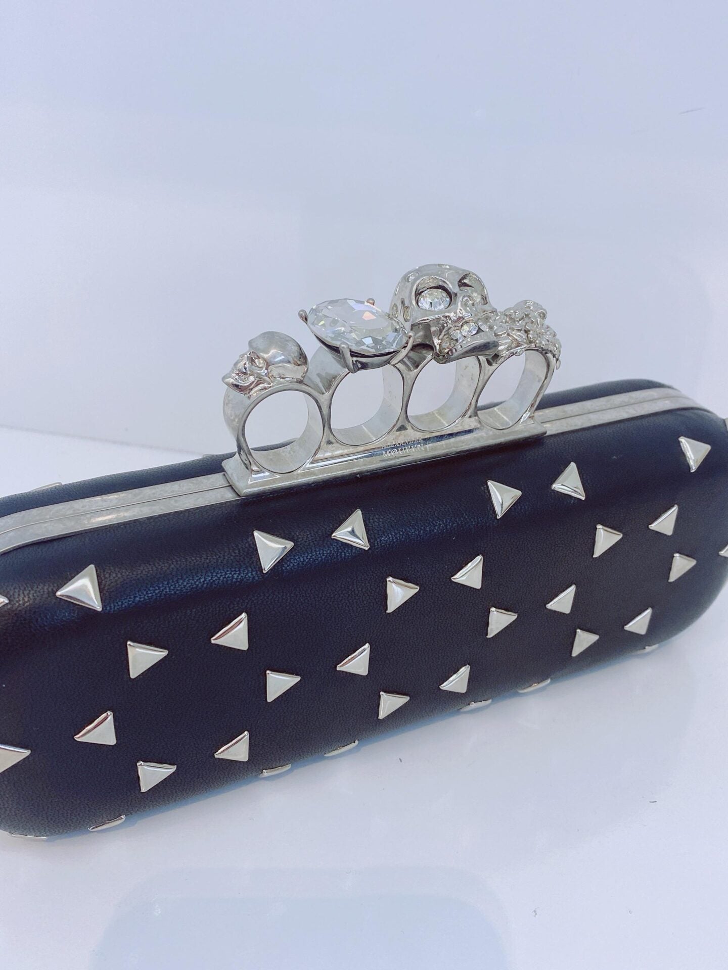 BLACK NAPPA TRIANGLE STUDDED KNUCKLE CLUTCH