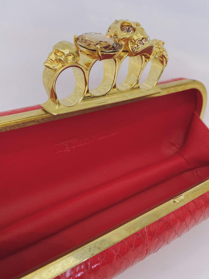 RED PYTHON SKIN KNUCKLE CLUTCH WITH CRYSTAL AND GOLD TONE HARDWARE