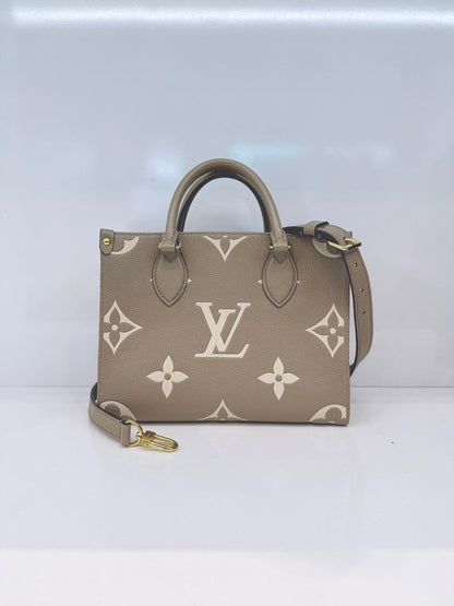 TOURTERELLE / CREAM MONOGRAM EMPREINTE LEATHER ONTHEGO PM HANDBAG