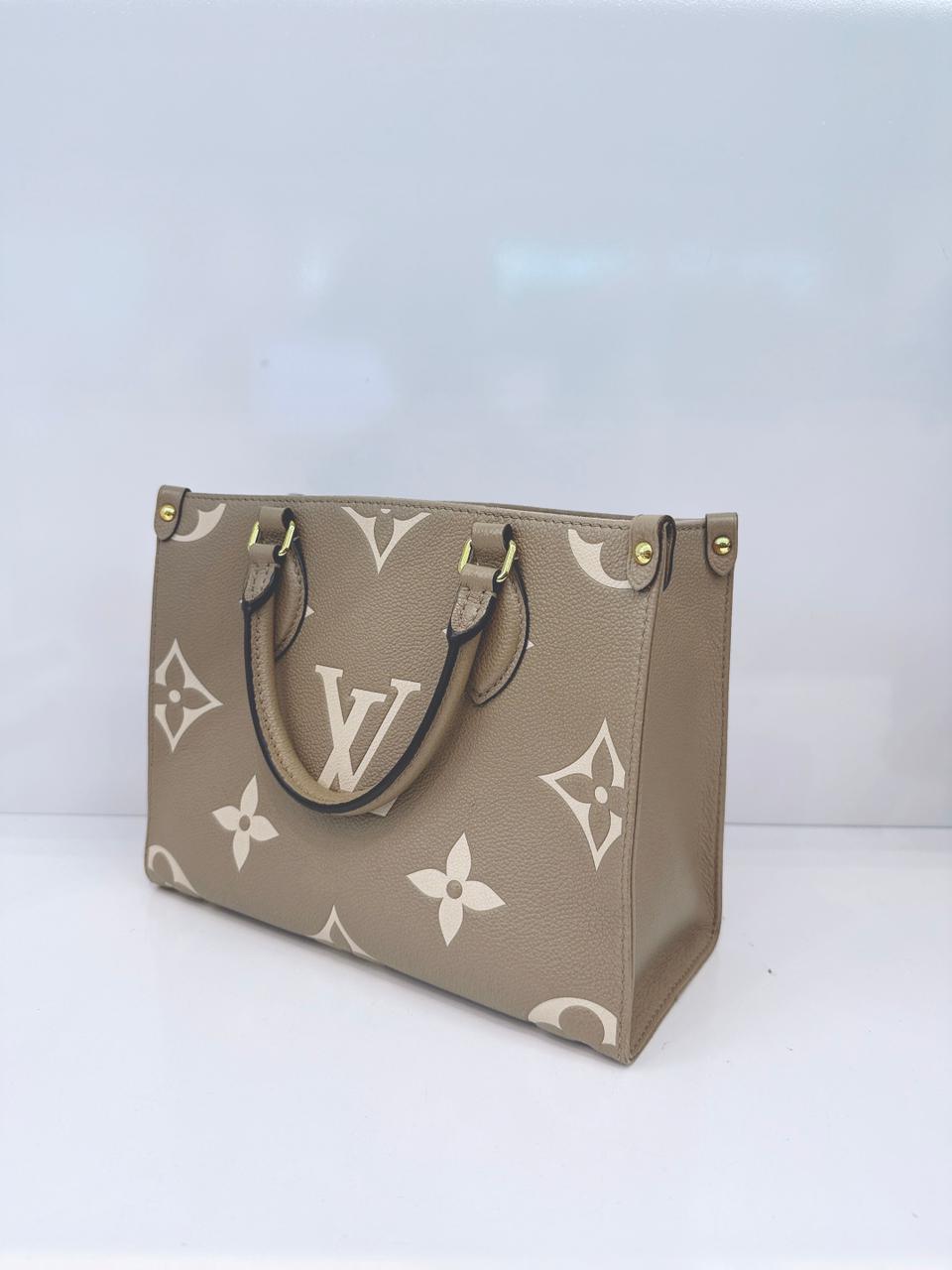 TOURTERELLE / CREAM MONOGRAM EMPREINTE LEATHER ONTHEGO PM HANDBAG