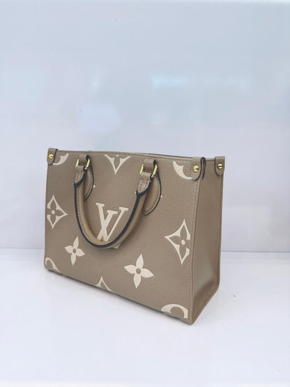 TOURTERELLE / CREAM MONOGRAM EMPREINTE LEATHER ONTHEGO PM HANDBAG