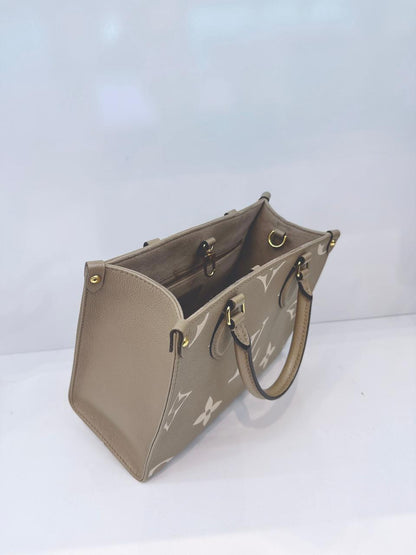 TOURTERELLE / CREAM MONOGRAM EMPREINTE LEATHER ONTHEGO PM HANDBAG