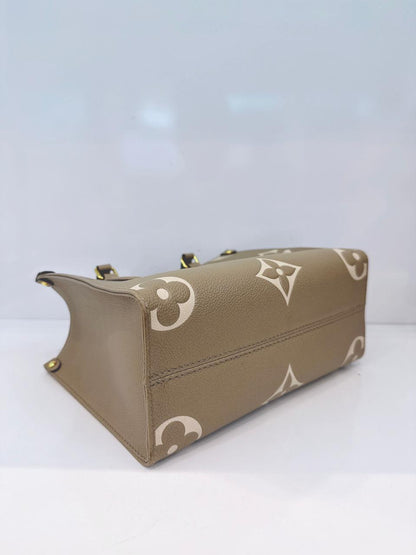 TOURTERELLE / CREAM MONOGRAM EMPREINTE LEATHER ONTHEGO PM HANDBAG