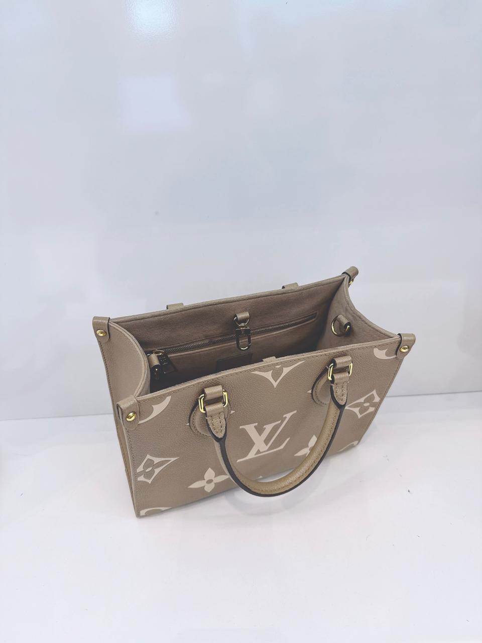 TOURTERELLE / CREAM MONOGRAM EMPREINTE LEATHER ONTHEGO PM HANDBAG