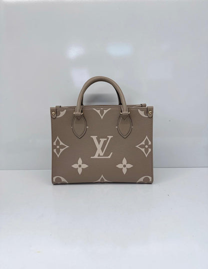 TOURTERELLE CRÈME BICOLOR MONOGRAM EMPREINTE LEATHER ONTHEGO PM TOTE BAG