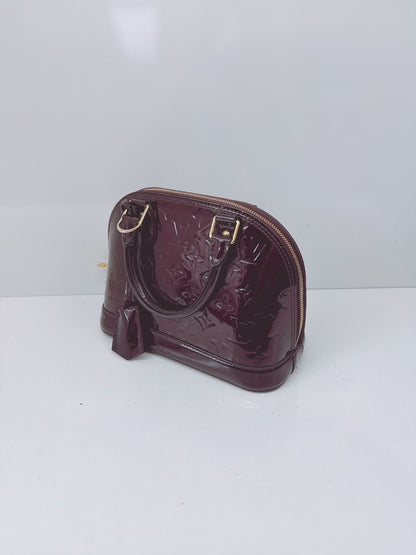 AMARANTE MONOGRAM VERNIS ALMA BB BAG