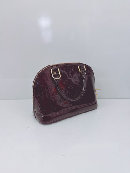 AMARANTE MONOGRAM VERNIS ALMA BB BAG