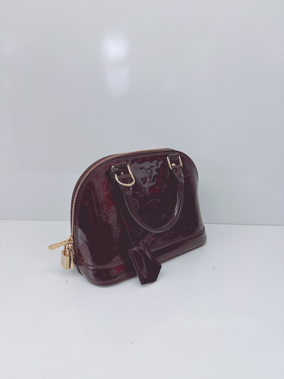 AMARANTE MONOGRAM VERNIS ALMA BB BAG