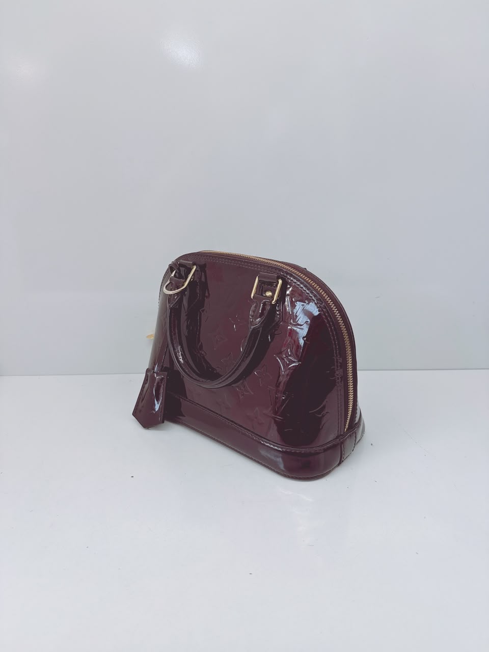 AMARANTE MONOGRAM VERNIS ALMA BB BAG