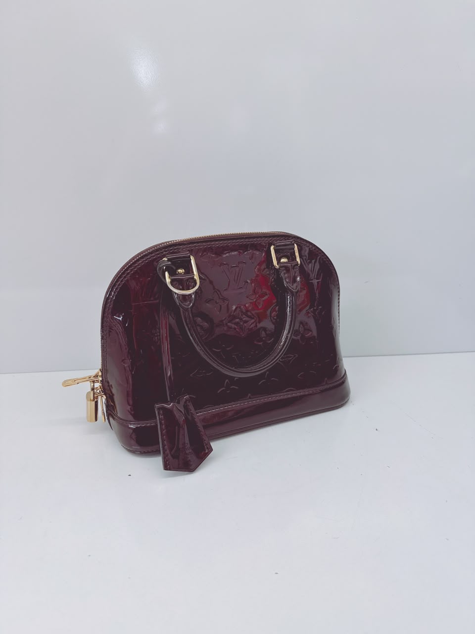 AMARANTE MONOGRAM VERNIS ALMA BB BAG