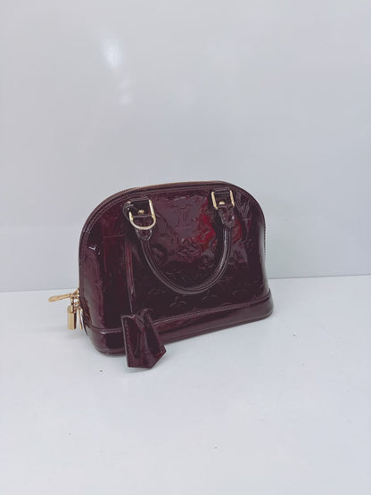 AMARANTE MONOGRAM VERNIS ALMA BB BAG