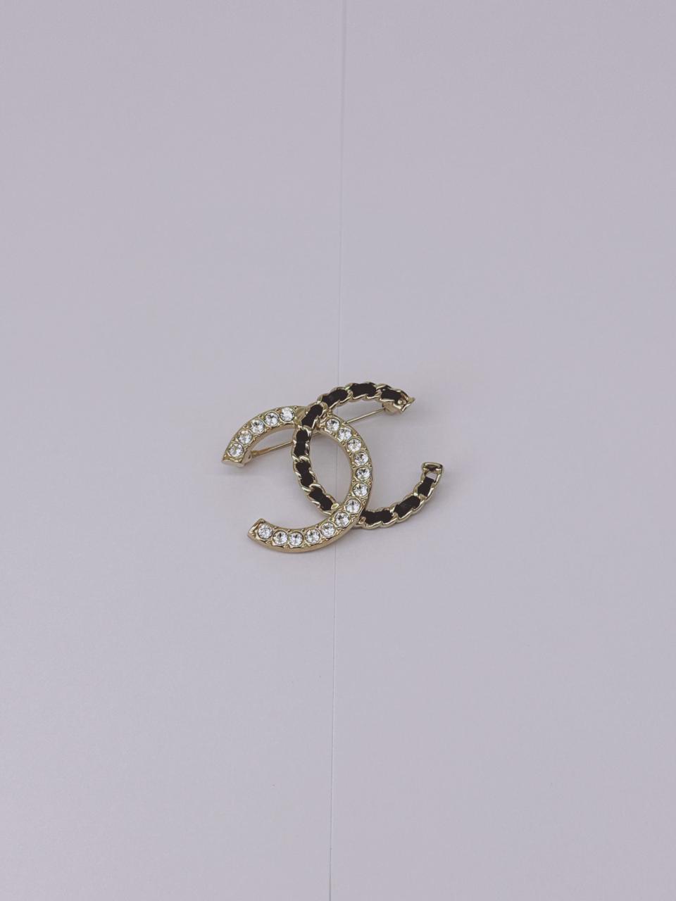 CC LOGO CRYSTAL AND LEATHER CHAIN GOLD TONE BROOCH